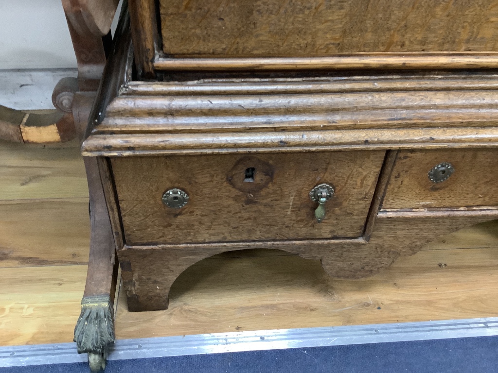 An 18th century oak chest on stand, width 105cm, depth 56cm, height 134cm